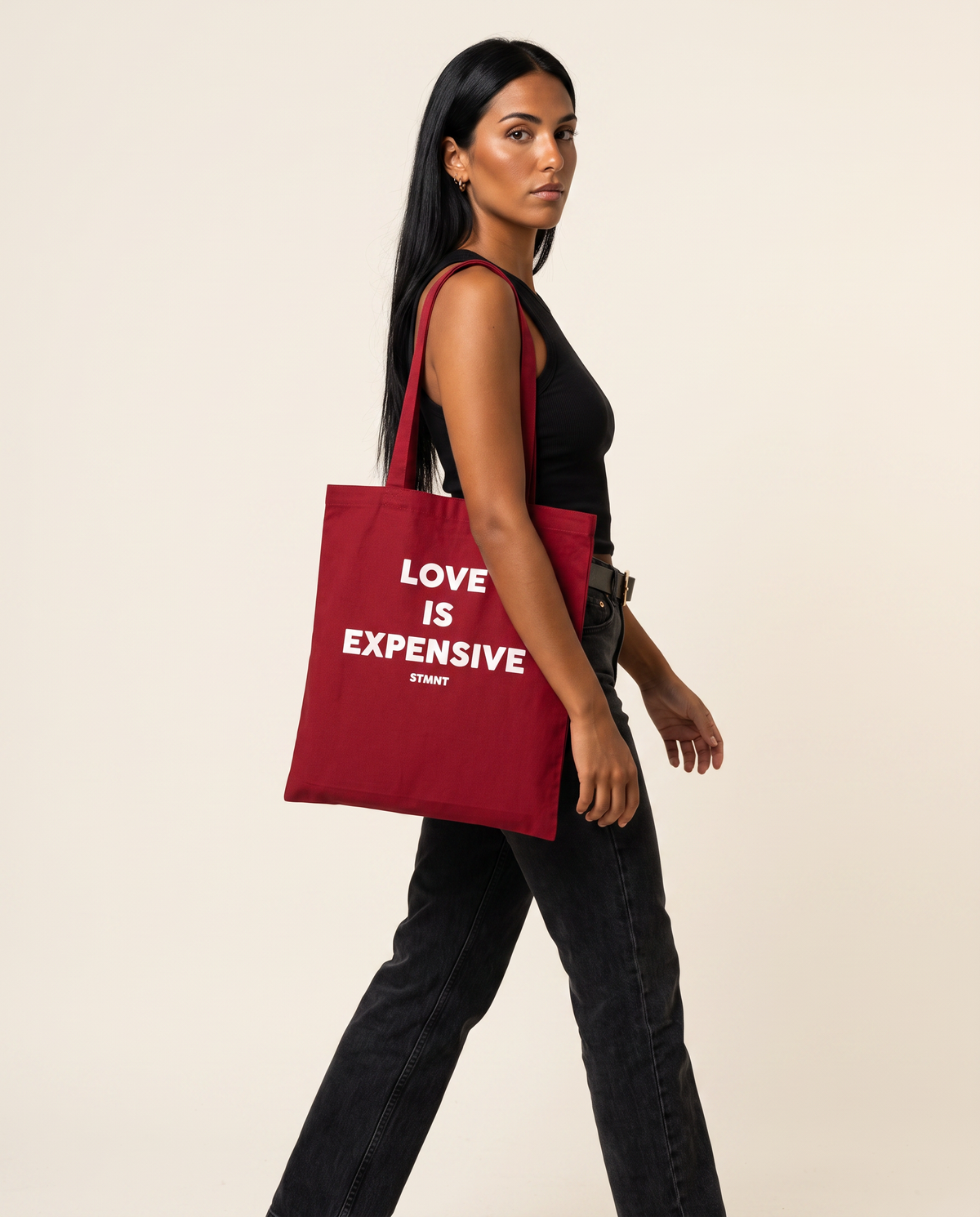 Love Is Expensive Tote Bag carried by model
