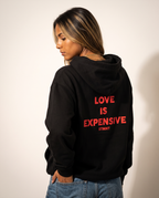 Love Is Expensive Oversized Hoodie worn by model