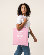 Sorry Not Sorry Tote Bag carried by model